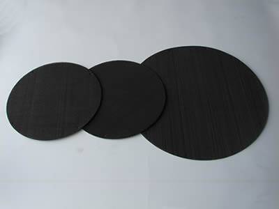 There are three black wire cloth extruder screen discs with different sizes.
