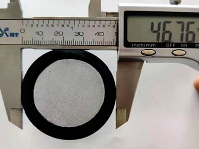 A rubber framed filter screen measured by the caliper.