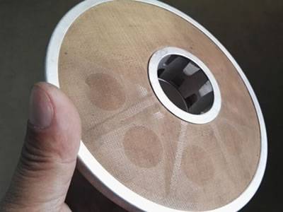 There is a extruder screen made from perforated and woven mesh.