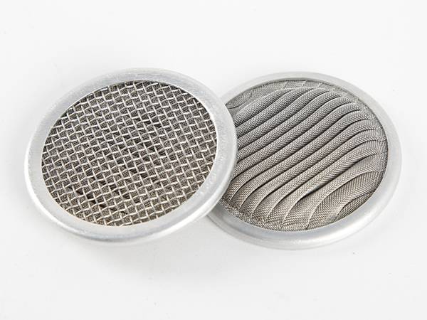 Two pieces of pleated filter discs on white background.