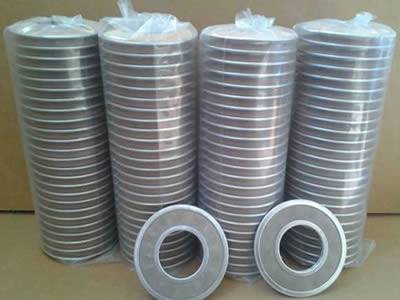 There are four stacks of ring-shaped extruder discs wrapped with plastic film.