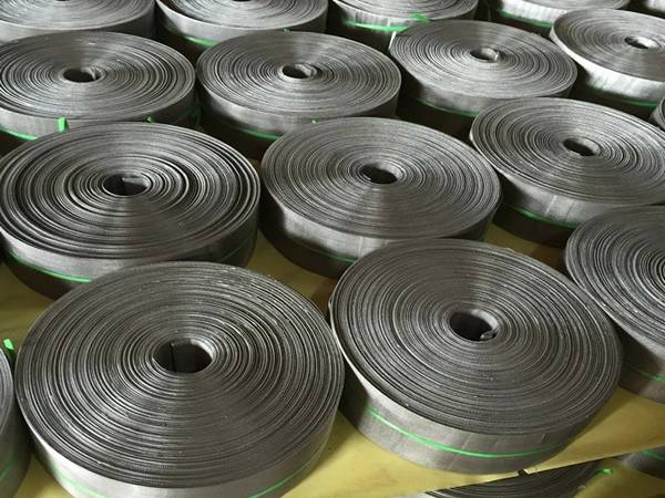 Several rolls of filter belts on the shelf.
